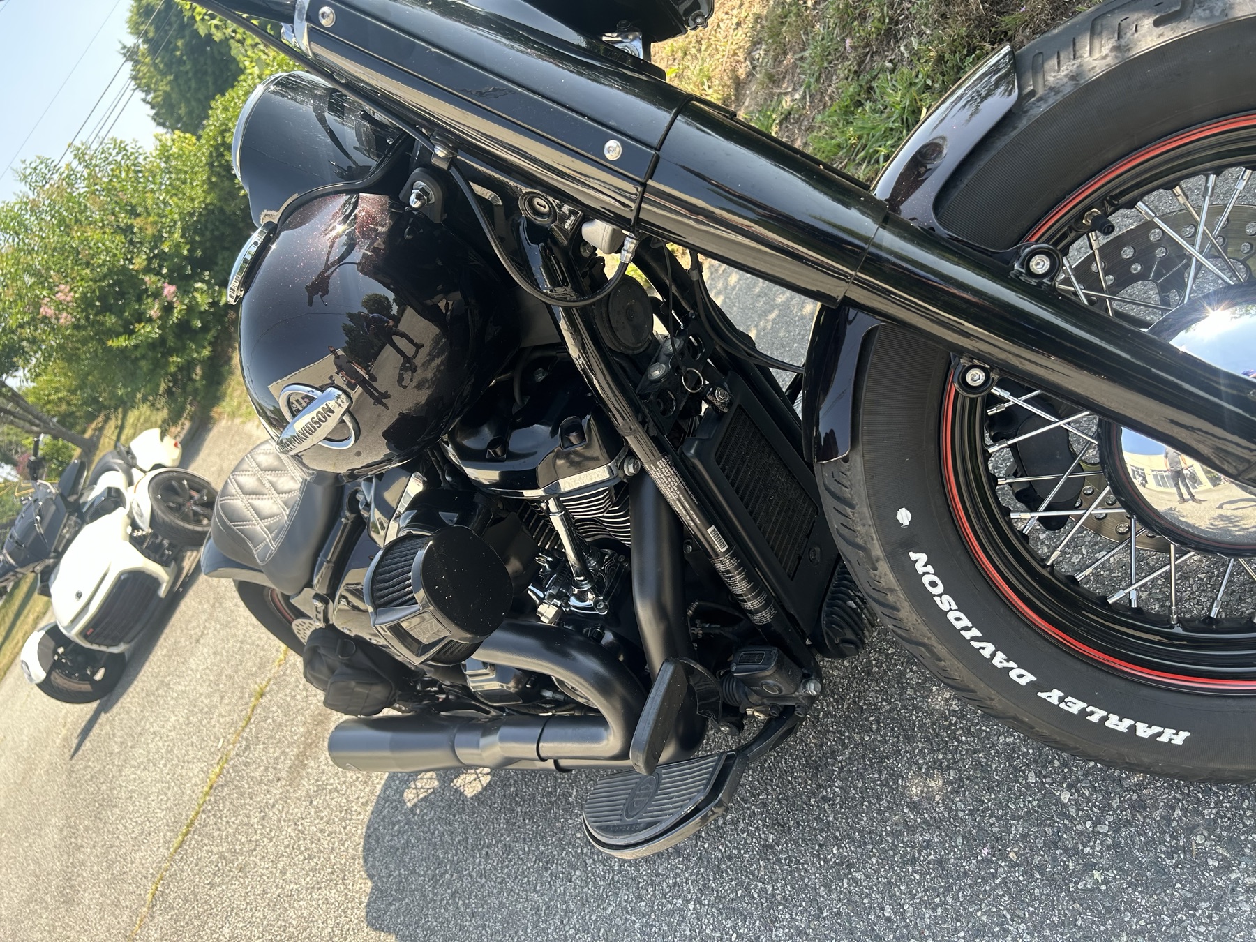 Custom black Harley-Davidson with diamond-stitched seat and blacked-out exhaust parked outside Southside Motorsports